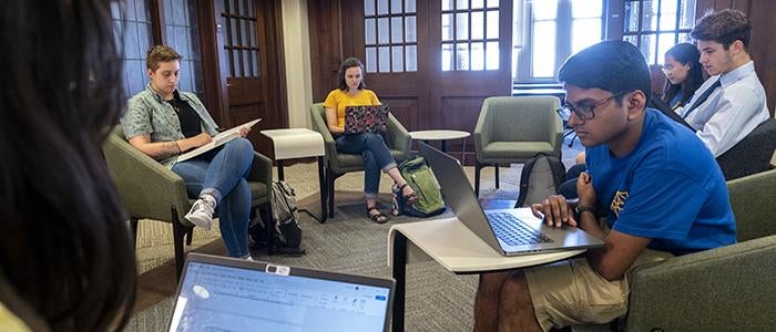 Students on laptops in Honors College study area