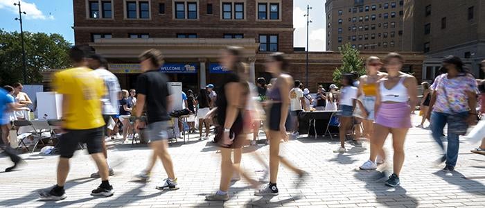 groups of people walking through student activity fair