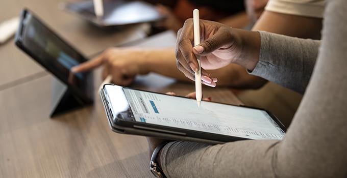 students using digital tablets and styluses during class