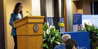 April Belback addressing Kessler Scholars during coin ceremony event