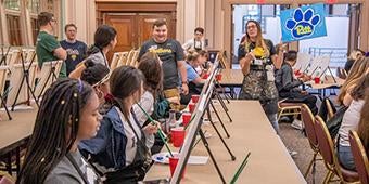 Provost Academy students participate in painting activity.