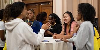 Provost Academy students mingle at a reception.